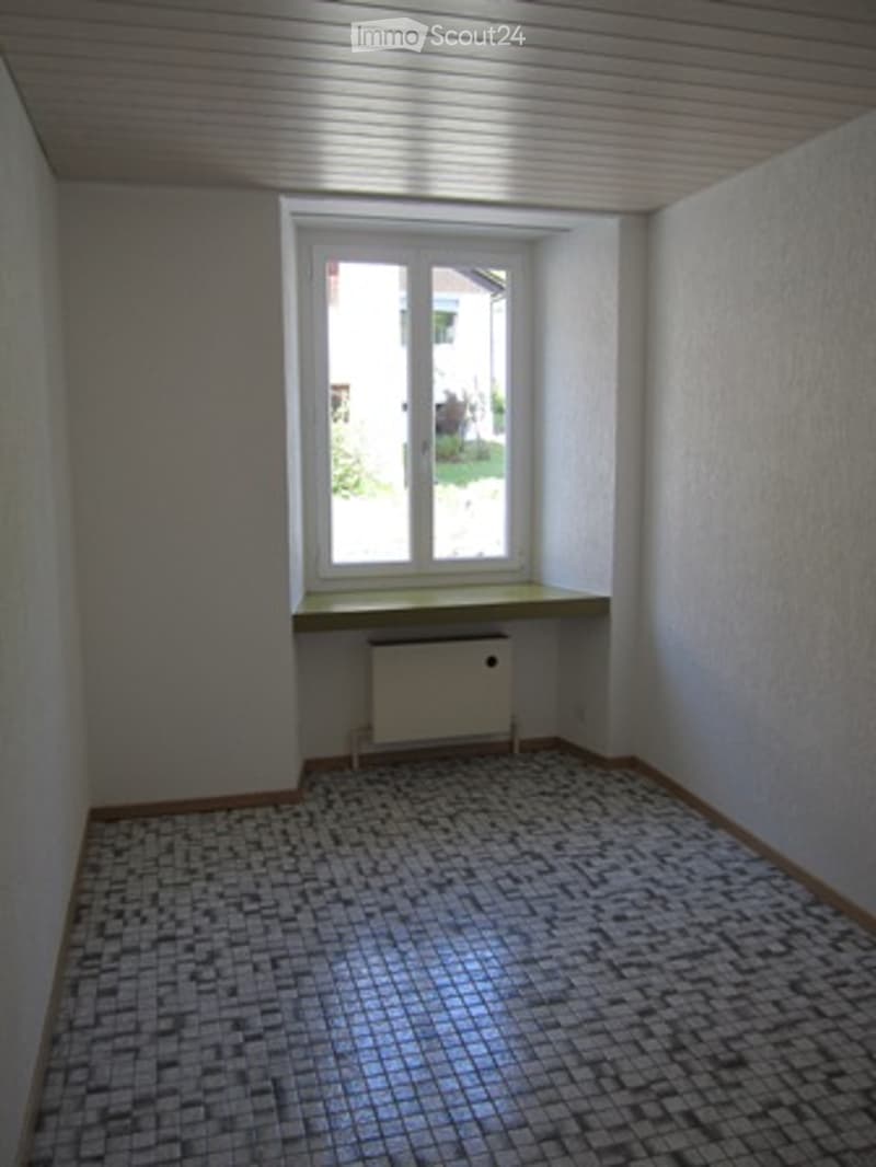 small room, white walls, window, radiator, tile flooring