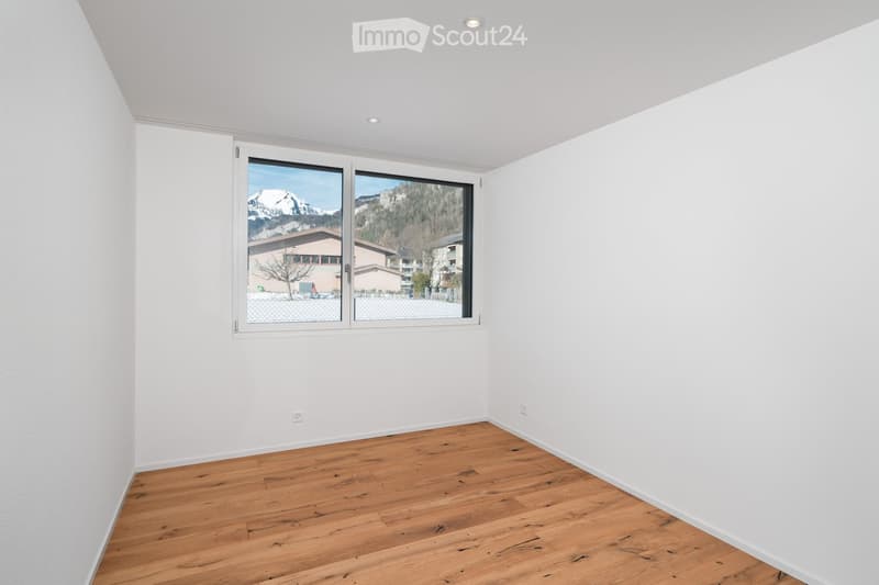 empty room, white walls, large window, wooden floor