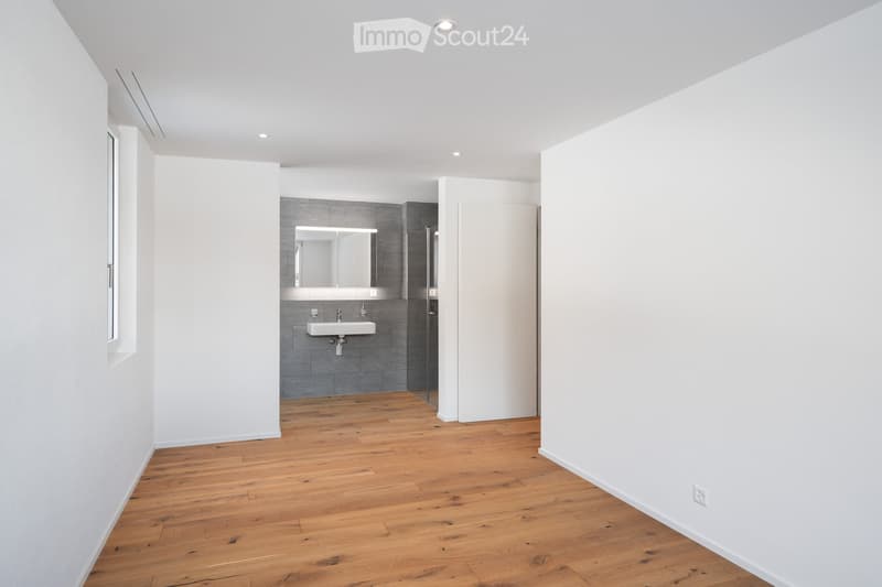Empty room, white walls, tiled floor, modern shower enclosure, white sink, mirror