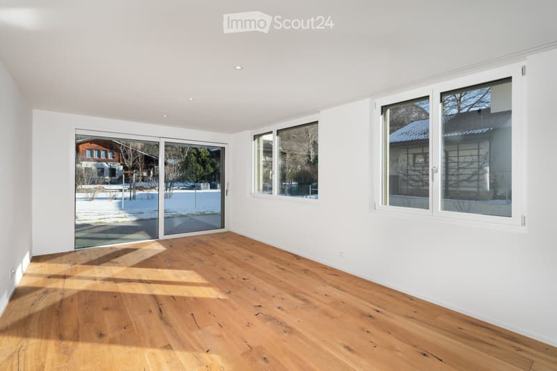 wooden floor, white walls, sliding glass doors to balcony, three large windows