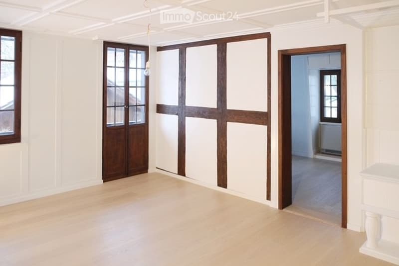 white walls, hardwood floor, wooden windows, open doorways