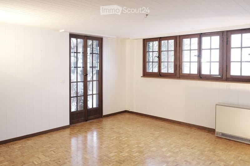 empty room, white walls, wooden floor, large windows, entrance door, electrical outlet