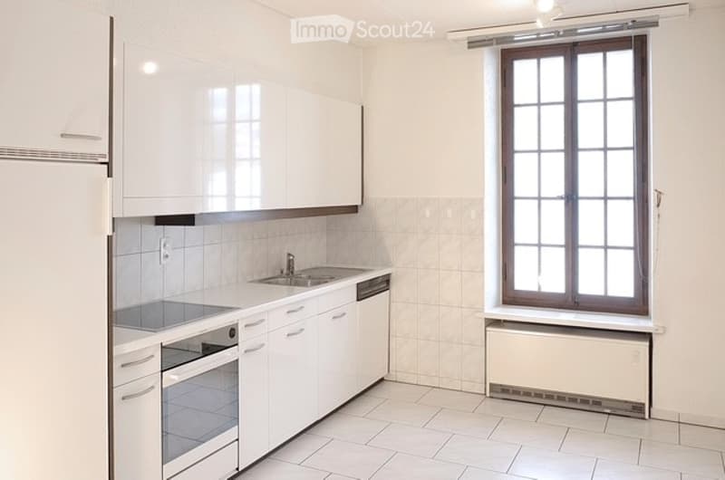 modern kitchen with white tiles, countertop, oven, sink, dishwasher, cabinets, radiator