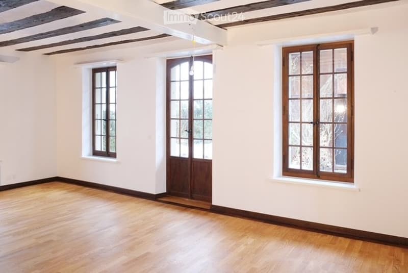 wooden floor, wooden door, glass windows, white walls, wooden beams ceiling