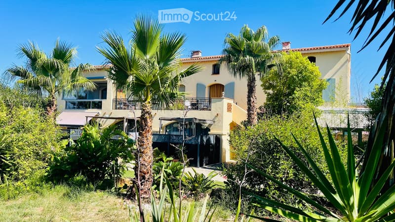 2 story house, cream walls, red roof, palm trees, terrace