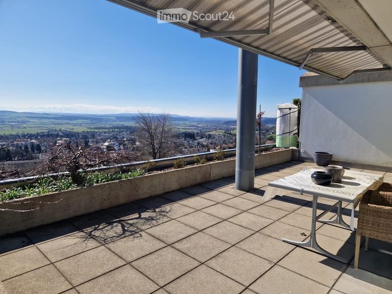 tiled floor, table, chairs, plants, metal railing, view of the city