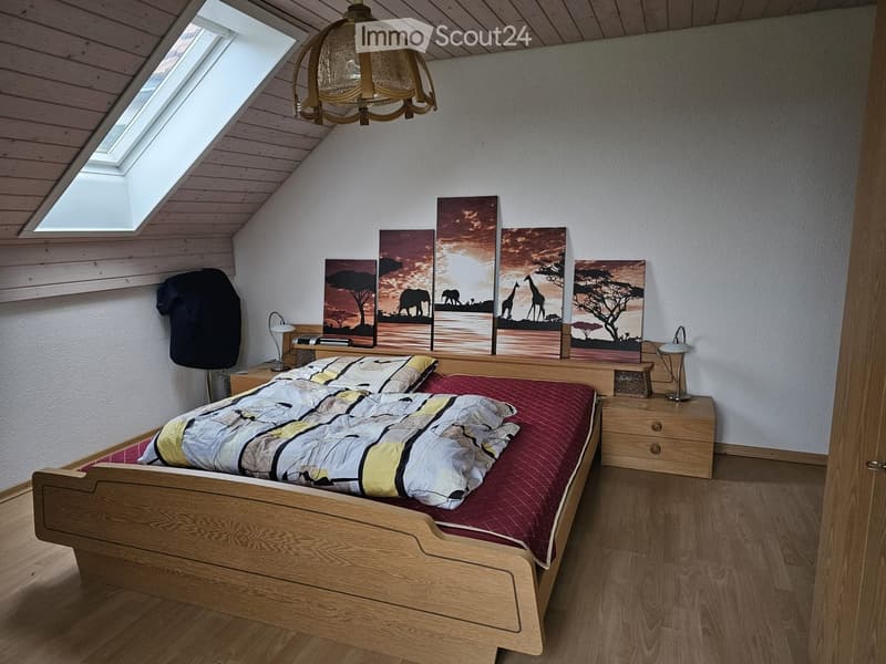 Wooden bed, lamps, nightstands, wall pictures, wooden floors, wardrobe