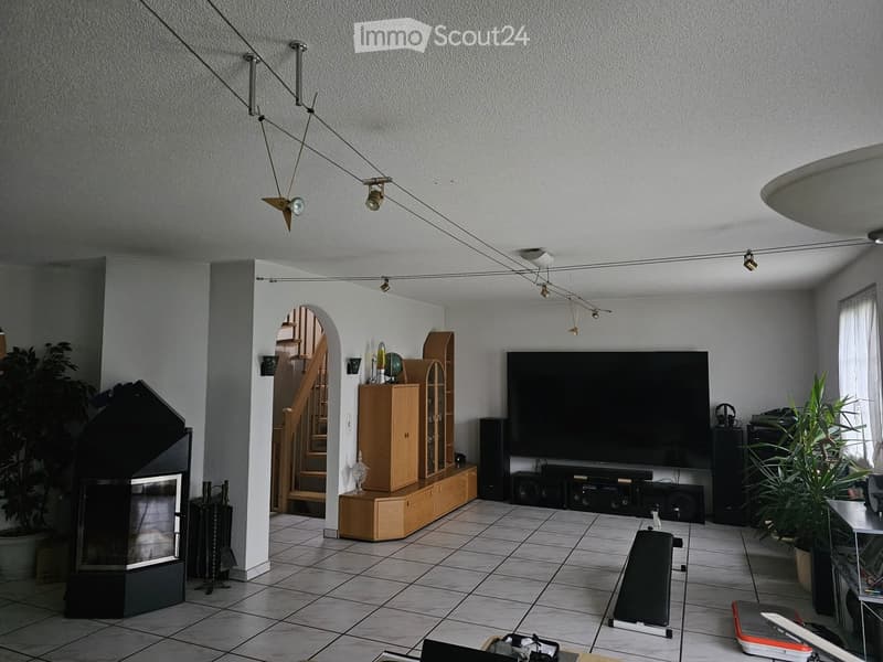 fireplace, TV, entertainment center, speakers, staircase, tiled floor
