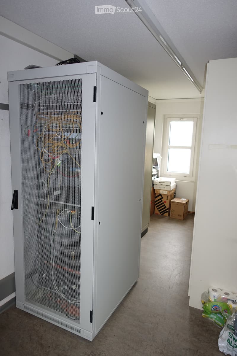 server cabinet, cables, boxes in the corner, window, fluorescent lighting