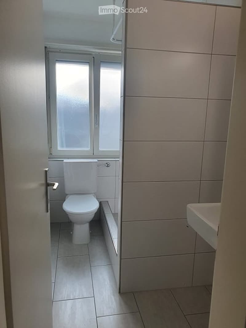 white tiled floor, white toilet, white bathtub, sink, glass window
