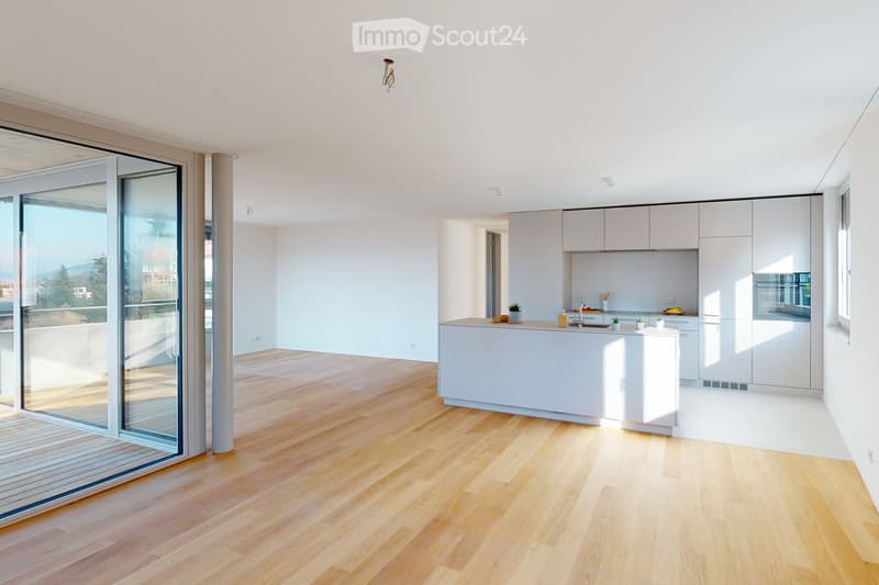 empty room, hardwood floors, sliding glass doors to balcony, large windows, white cabinetry, kitchen island, kitchen appliances