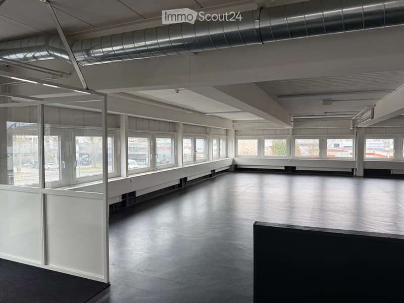 Empty room with white walls, large windows, and a polished concrete floor. No furniture or equipment is present.