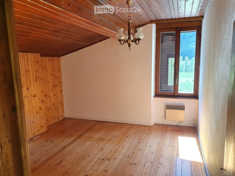 empty room, wooden floor, wooden paneling, chandelier, large window with shutters, heater