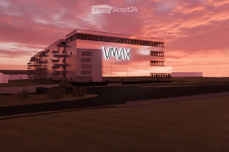 modern building, illuminated at dusk, glass windows, name plate 'VMAX' on facade, several floors