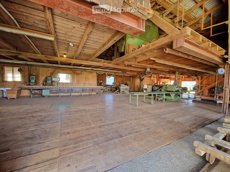 Wooden interior, industrial setting, wooden ceiling beams, machinery