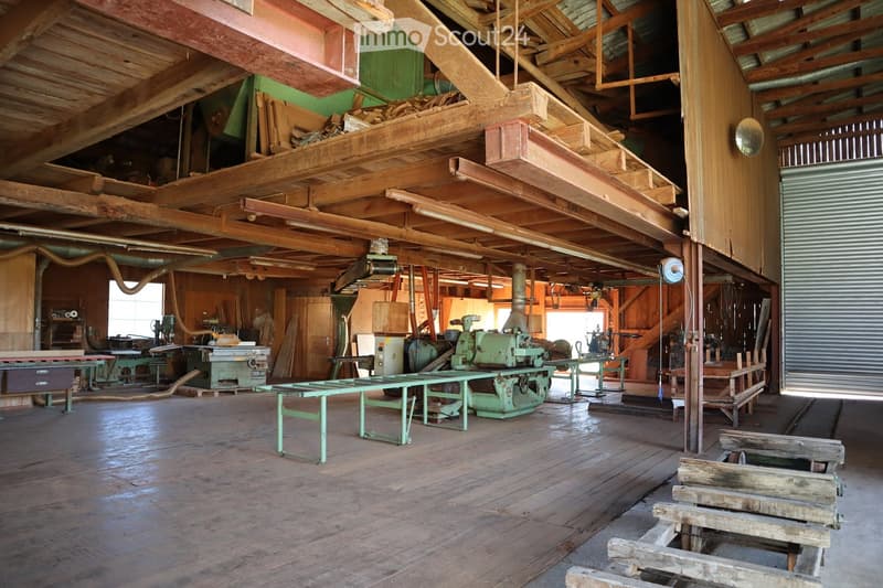 large wooden workshop space, high ceilings, industrial wooden machinery