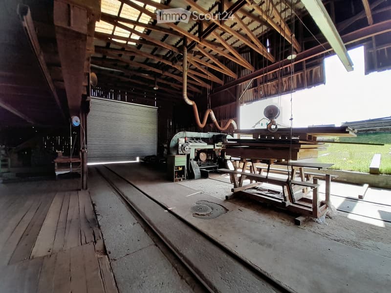 wooden flooring, large open space, machinery and equipment, concrete floor, wooden roof structure