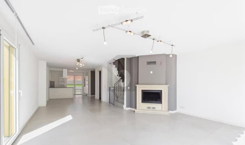 Empty room with staircase, fireplace, sliding glass door, and tiled floor