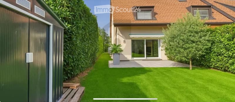well-maintained garden, lawn, wooden deck, sliding doors, green hedge