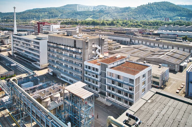Large industrial complex with several buildings, metal structures, and machinery equipment.
