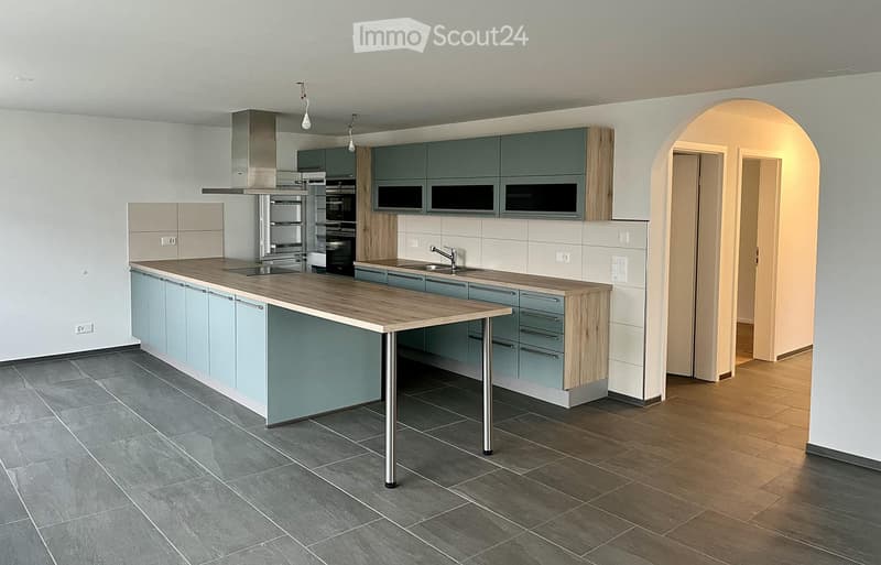 Central kitchen with island, wooden cabinets, tiled floor, central ventilation, sink, oven, refrigerator