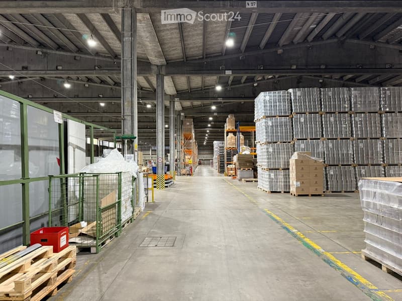 industrial warehouse, spacious, high ceilings, concrete floor, metal racks, large aisle, storage boxes, metal storage bins