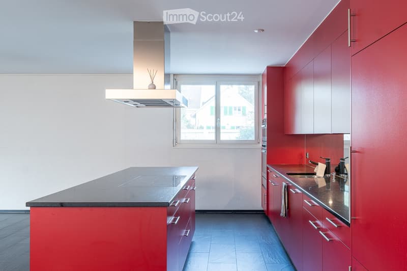red cabinets, central island, granite countertop, modern appliances, large window
