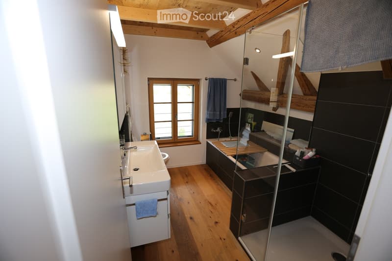 large walk in shower, bathtub, wash basin, window, towel hanger, light fixtures