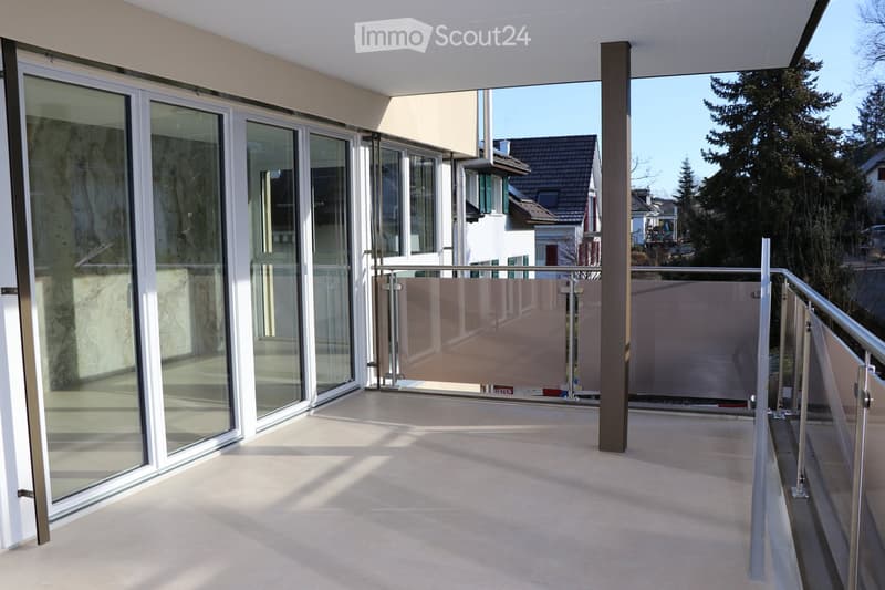 modern balcony with sliding glass doors, metal railings, and tiled flooring