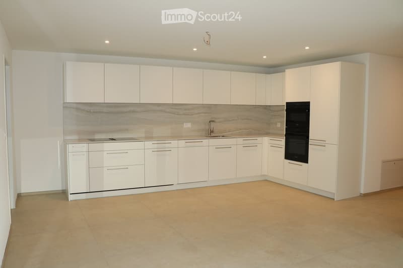 modern kitchen with built-in appliances, white cabinets, marble countertop, tiled floor