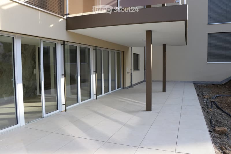 tiled walkway, large glass doors, balcony, brown pillars