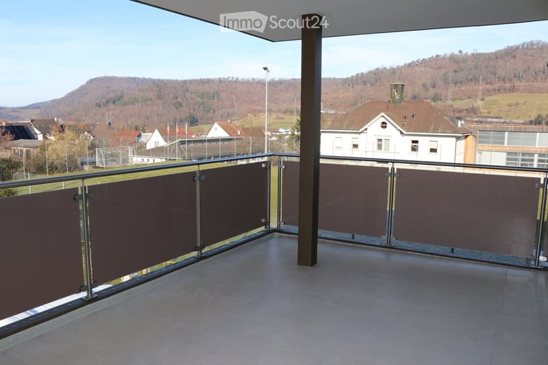 empty balcony with metal railings and glass panels