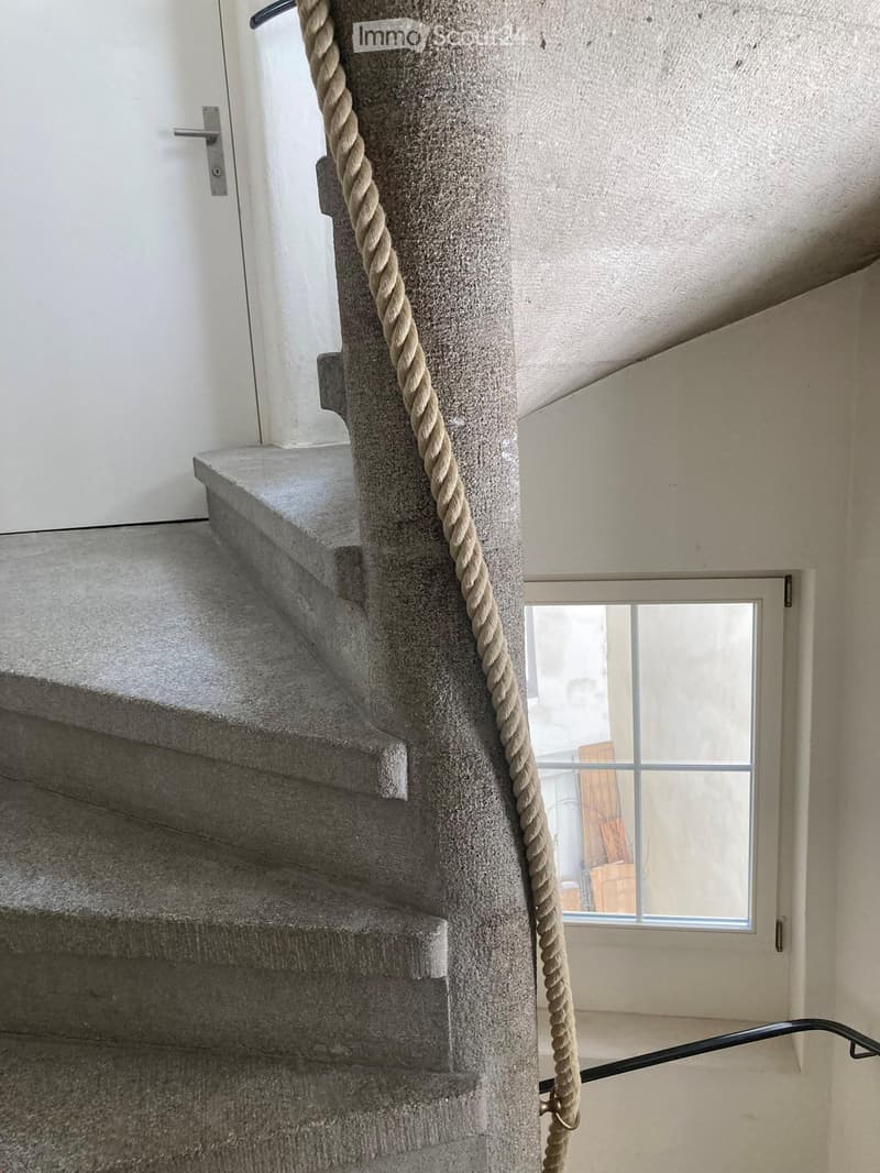 spiral staircase, rope railing, concrete steps, white door