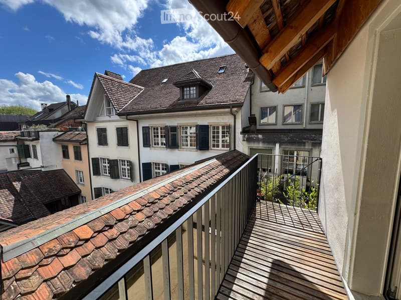 Balcony / Terrace. Balcony overlooking a historic urban area with traditional buildings, tiled roofs, and greenery.