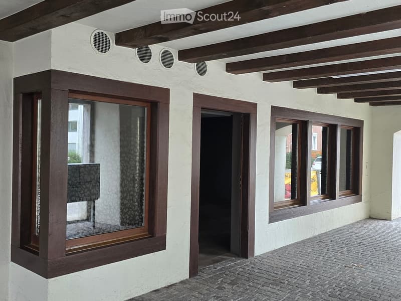 white wall, wooden beam ceiling, wooden framed glass windows, glass paneled door