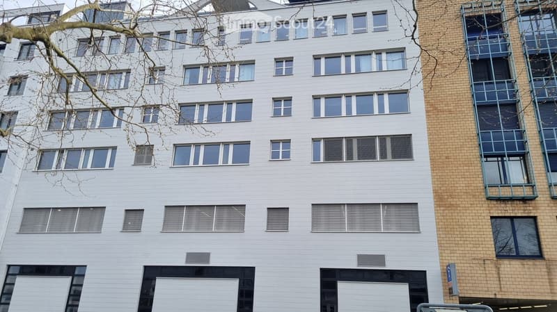 6 story building, modern style, white exterior, large windows, garage entrance