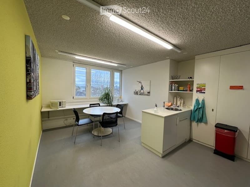 kitchen-dining room area, table and chairs, microwave, sink, cabinets, trash can