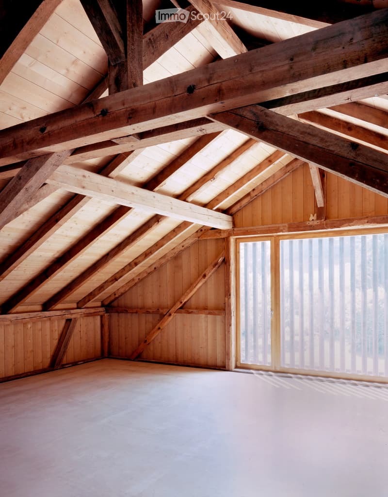 exposed wooden beams, wooden wall, white floor, large windows