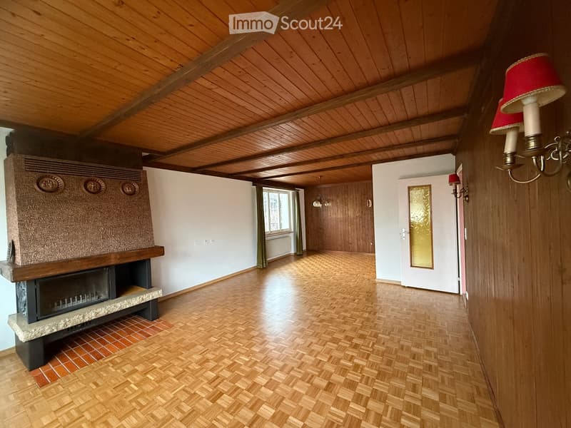 Fireplace, wooden floor, wooden ceiling, white walls, open space