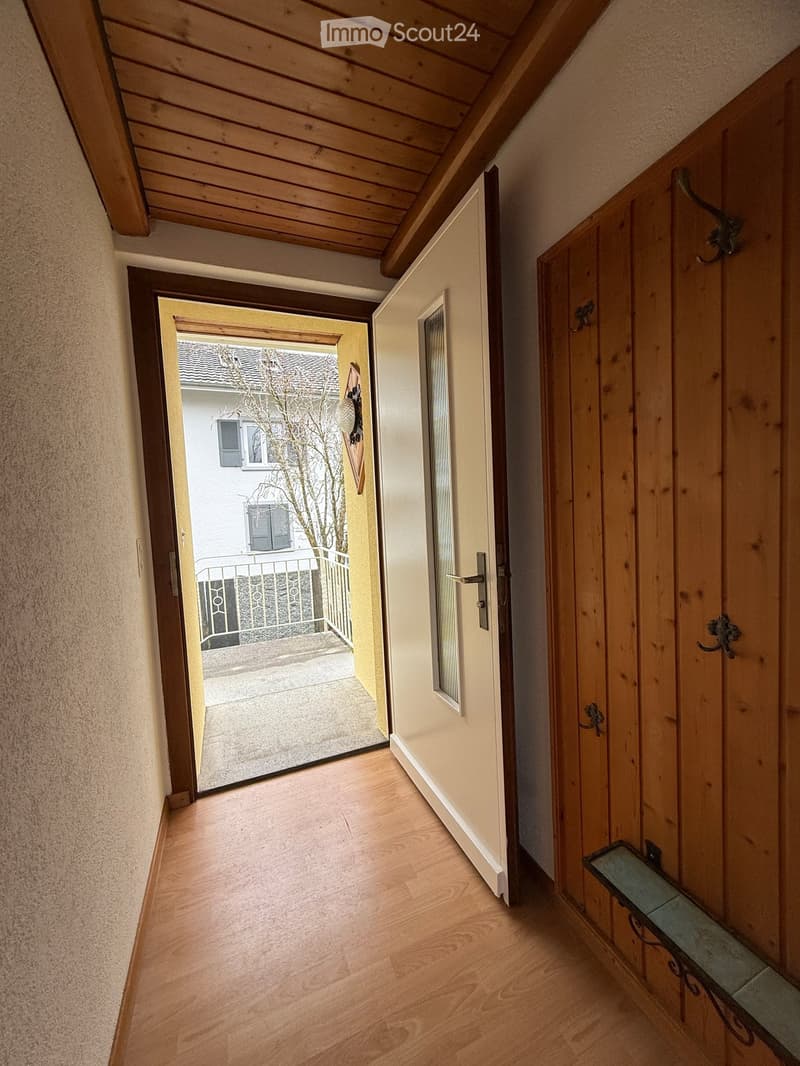 open door, wooden floors, hallway, white wall, open balcony, white door