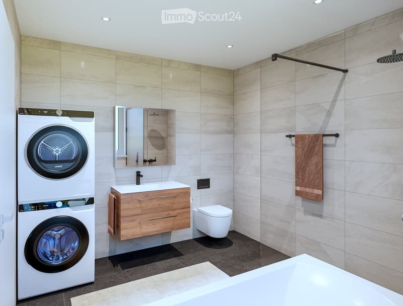 White laundry appliances, sink, vanity, modern mirror, tiled walls, shower, towel rack, built-in washer and dryer, floor-mounted toilet, large bathtub