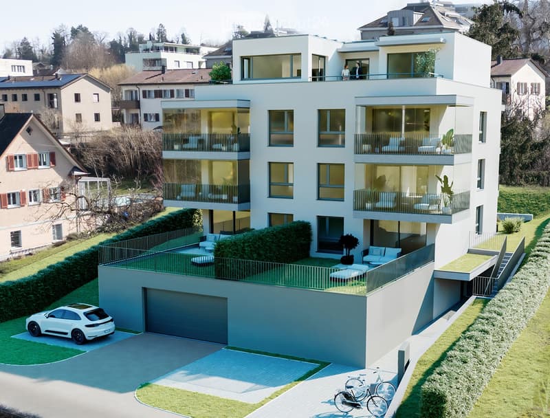 4 story apartment, white exterior, multiple balconies, garage, large front garden, bicycles in front