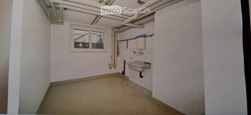 Empty room with a window, pipe and sink