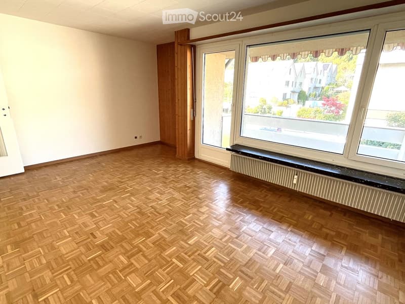 wooden floor, white walls, sliding glass doors, large windows, wooden bench, wooden cabinet, power outlets