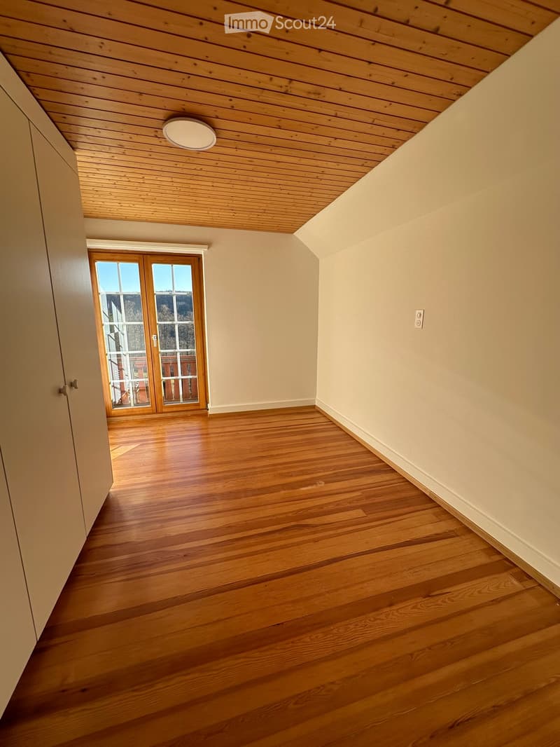 empty room, wooden floors, wooden ceiling, glass doors leading to balcony, closet