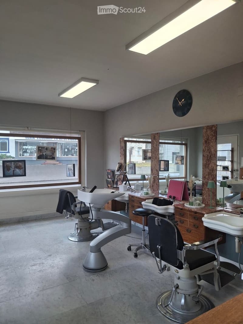 Empty room, barber shop, two barber chairs, mirrors, wooden cabinets, sinks, ceiling lights