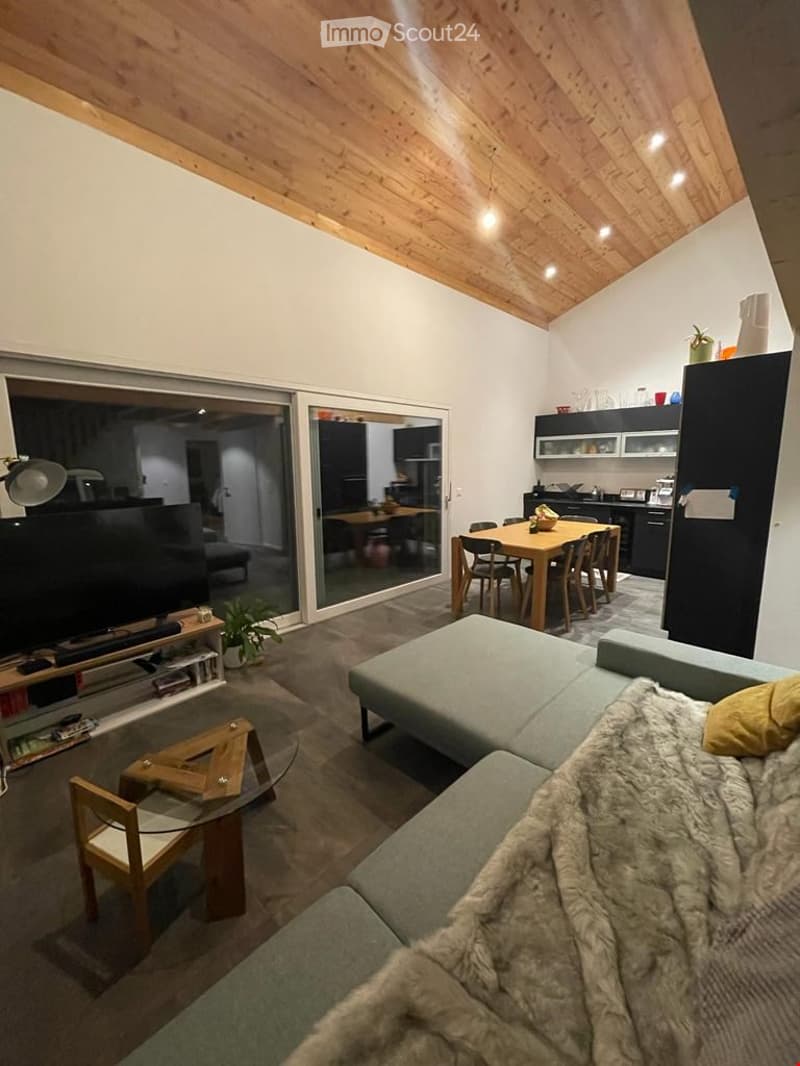 open floor plan, large windows, modern furniture, wooden ceiling