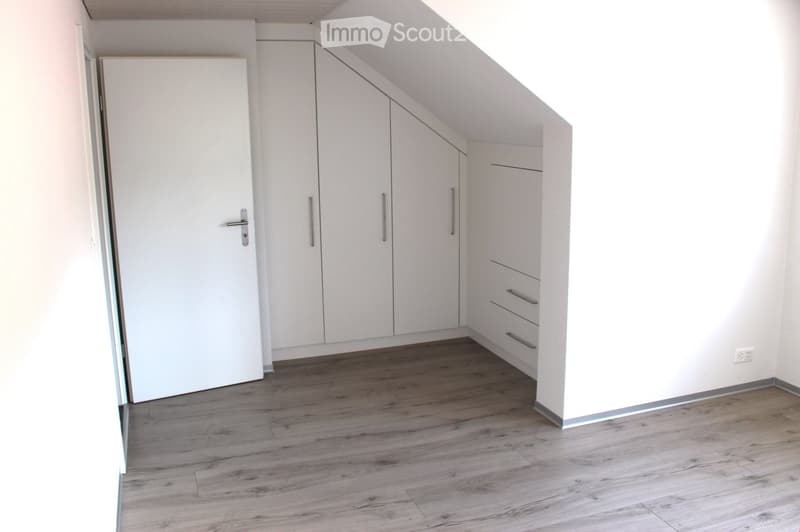 empty room, white doors and walls, built-in wardrobes, wooden floor