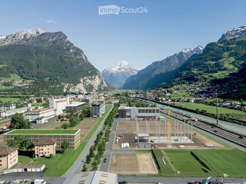 cityscape with multiple buildings, mountainous terrain, ongoing construction, river, road