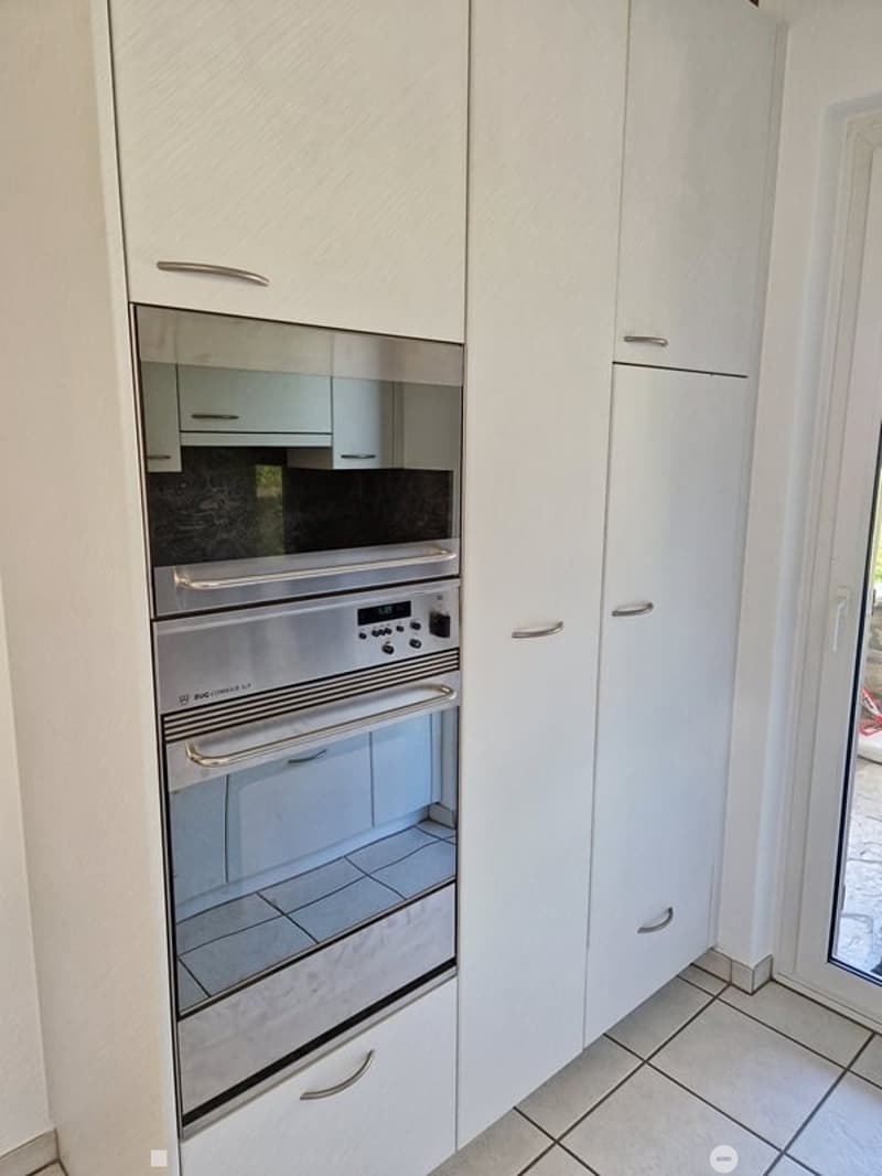 white cabinets, white tiled floor, double oven, dishwasher, tile backsplash